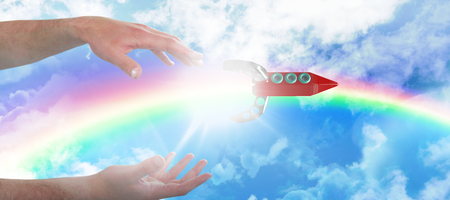 Cropped hands of man gesturing against idyllic view of cloudscape against skyの写真素材
