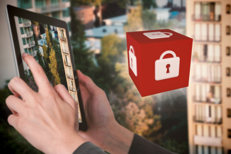 Close-up of businesswoman holding digital tablet against sunlight falling on treesの写真素材
