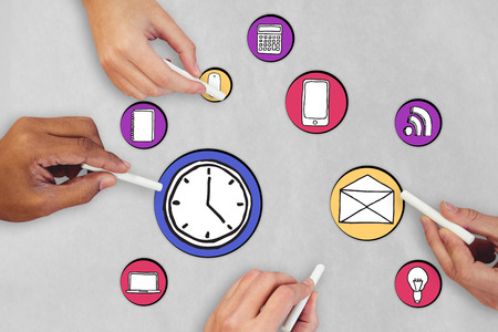 Cropped hands of people holding chalks against brown grocery bag textureの写真素材