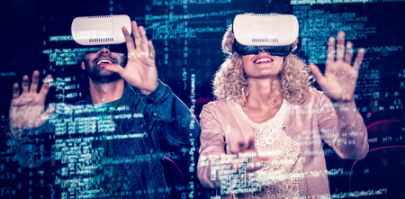 Image of data against couple using virtual reality headsetの写真素材