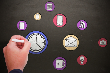 Hand writing with chalk against blackboardの写真素材