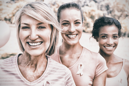 Portrait of confident female volunteers participating in breast cancer awarenessの写真素材