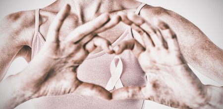 Woman wearing pink ribbon for breast cancer awareness on white backgroundの写真素材