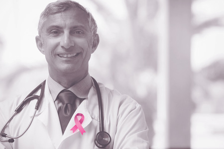 Breast cancer awareness ribbon against doctor smilingの写真素材