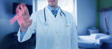 Doctor touching an digital screen  against doctor consulting with patientの写真素材