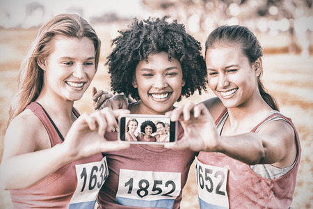 Runners supporting breast cancer marathon and taking selfies in parklandの写真素材