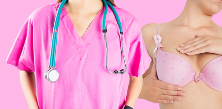 Mid section of nurse with stethoscope against pink backgroundの写真素材