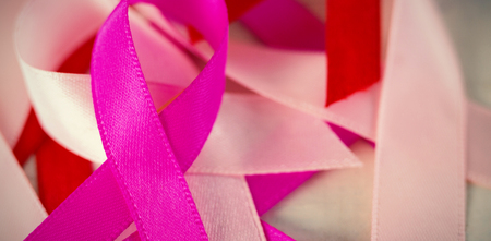 Close-up of Cancer Awareness ribbons on white wooden tableの写真素材