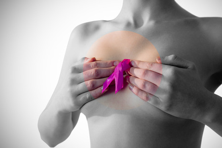 Nude woman with breast cancer ribbon on white backgroundの写真素材