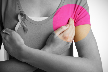 Woman with breast cancer ribbon on white backgroundの写真素材