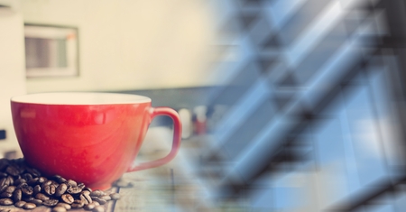 Digital composite of Red coffee cup with beans and blurry window transitionの写真素材
