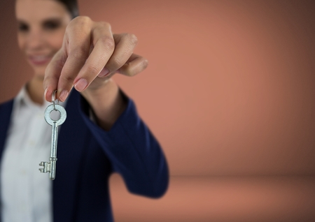 Digital composite of Woman holding key in front of Vignetteの写真素材