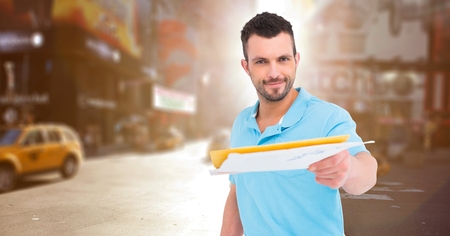 Digital composite of Delivery man handing out letters against blurry street with flare