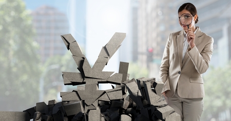 Digital composite of Broken concrete stone with money Yen symbol and businesswoman in cityscapeの写真素材
