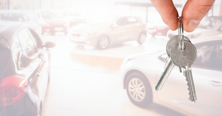 Digital composite of Hand Holding key in front of vignetteの写真素材