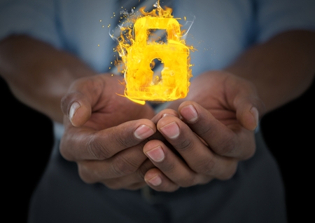 Digital composite of hands with lock fire icons over. Black backgroundの写真素材