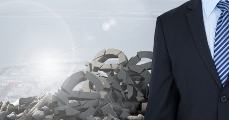 Digital composite of Broken concrete stone with money symbol and businessman in cityscapeの写真素材