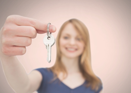 Digital composite of Woman Holding key in front of vignetteの写真素材