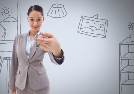 Digital composite of Woman Holding keys with home drawings in front of vignetteの写真素材