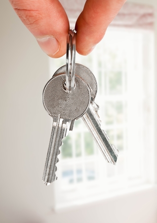 Digital composite of Hand Holding key by windowの写真素材