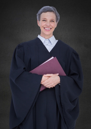 Digital composite of Female judge with book against grey wallの写真素材
