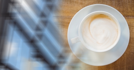 Digital composite of Overhead of white coffee cup and blurry window transitionの写真素材