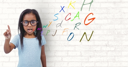 Digital composite of girl speaking with colour letters coming up from mouthの写真素材