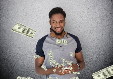 Digital composite of texting money. Young man with phone. Money coming up from phone