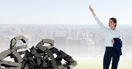 Digital composite of Broken concrete stone with euro symbol and businesswoman in cityscapeの写真素材