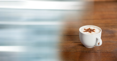 Digital composite of White coffee cup with star in foam and blurry blue transitionの写真素材