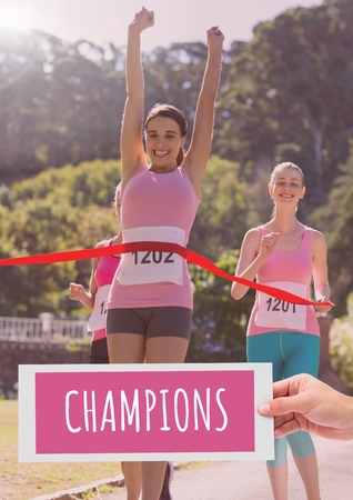 Digital composite of Champions Text and Hand holding card with pink breast cancer awareness women marathon runの写真素材