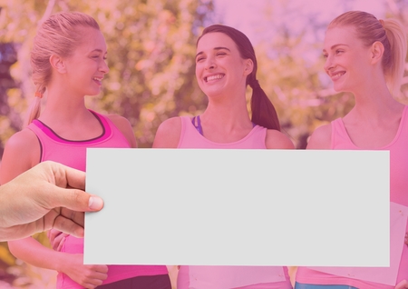 Digital composite of Hand holding card with pink breast cancer awareness womenの写真素材