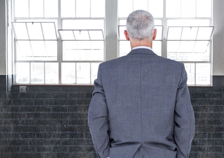 Digital composite of Businessman looking at windowsの写真素材