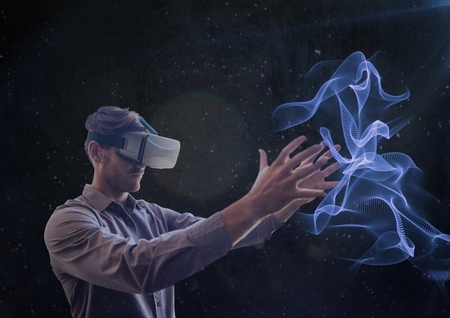 Digital composite of man using vr headset holding projection