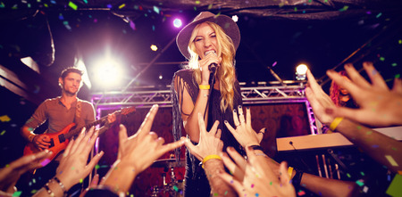 Flying colours against singer performing on stage at nightclubの写真素材