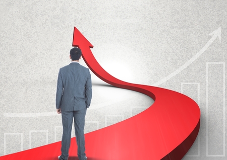 Digital composite of businessman standing on red arrowの写真素材
