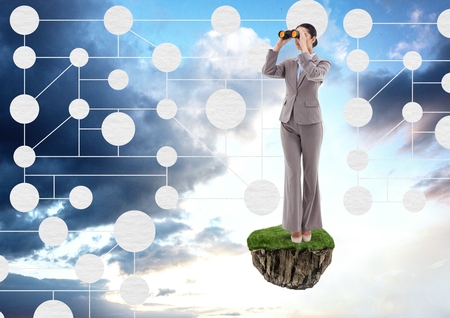 Digital composite of Businesswoman with binoculars on floating rock platform with interface mind map in skyの写真素材