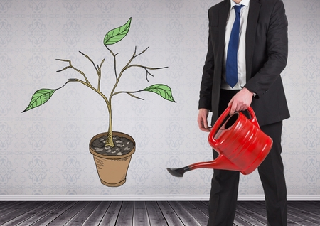 Digital composite of Man holding watering can and Drawing of Plant branches and leaves on wallの写真素材