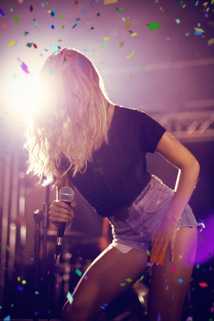 Flying colours against singer with long hair on stage at concertの写真素材