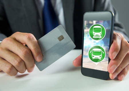 Digital composite of Hand holding phone with transport icons and bank cardの写真素材