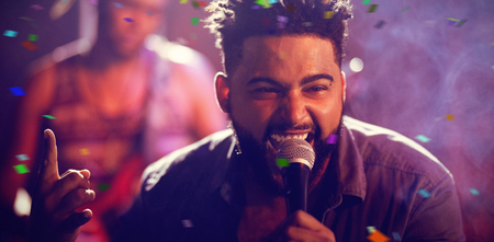 Flying colours against singer performing on stage at nightclubの写真素材