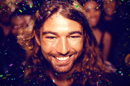 Flying colours against portrait of man at nightclub