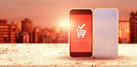 Close-up of mobile phones against sunlight falling on buildings during sunsetの写真素材