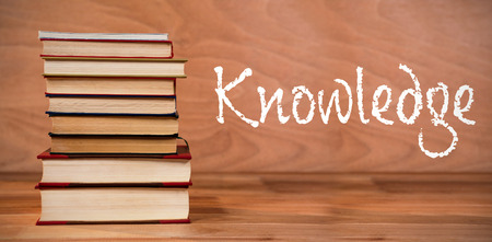 Knowledge text against white background against hardcover books stackの写真素材