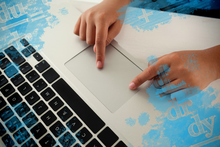 Digital composite image of equations against schoolboy using laptopの写真素材