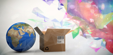 World map and brown cardboard box against abstract glowing black background