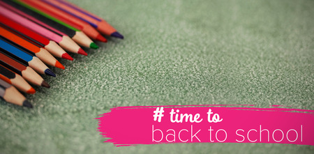 Back to school text with hashtag  against close-up of multi colored pencils arranged