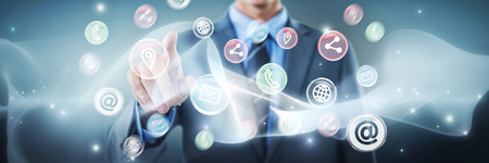 Well dressed businessman pointing against grey vignetteの写真素材