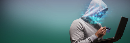 Hacker using laptop while holding credit card against turquoise and purple backgroundの写真素材