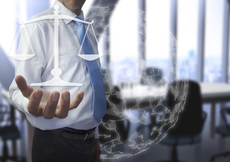 Digital composite of businessman holding justice iconの写真素材